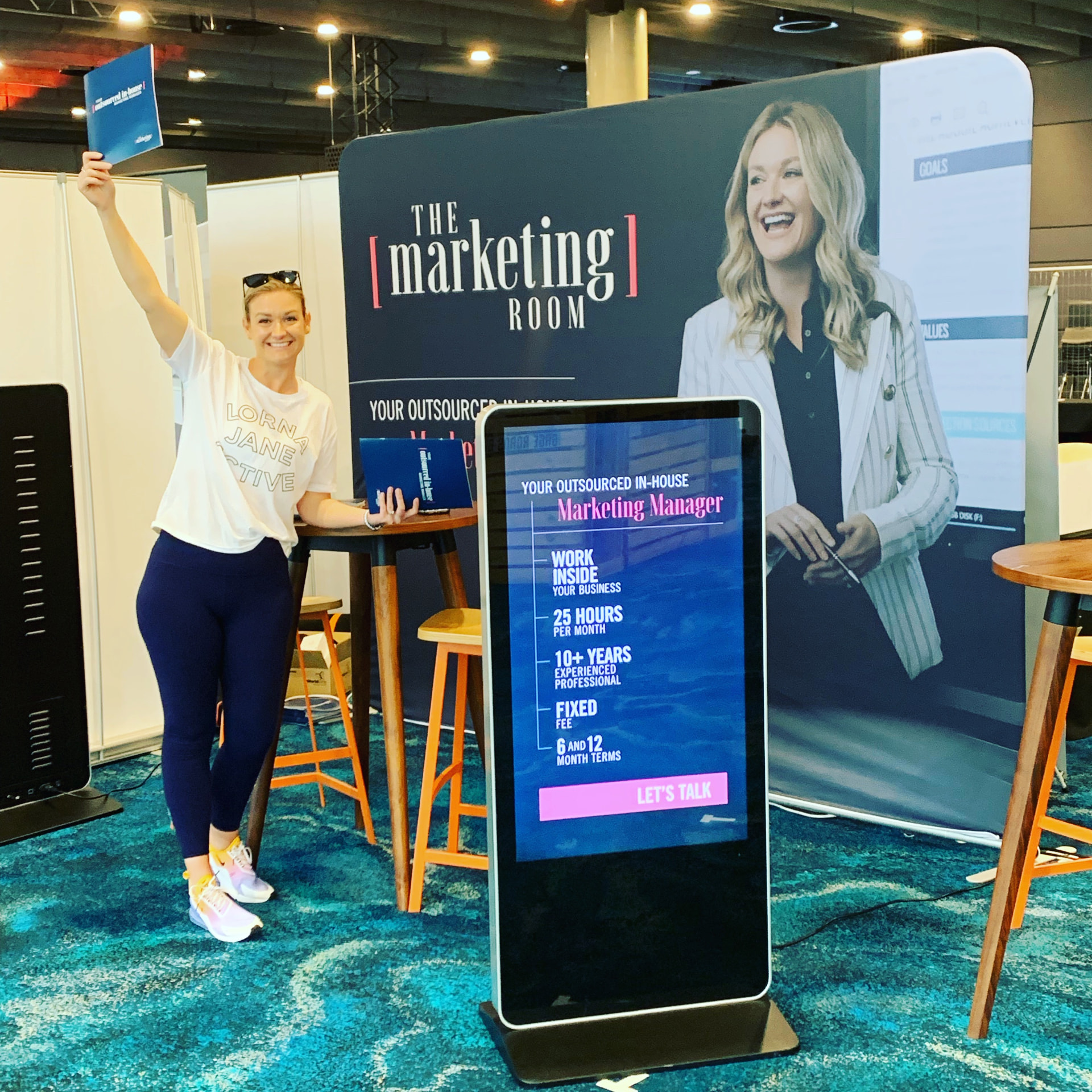 A TMR marketer celebrating at The Marketing Room's expo stand