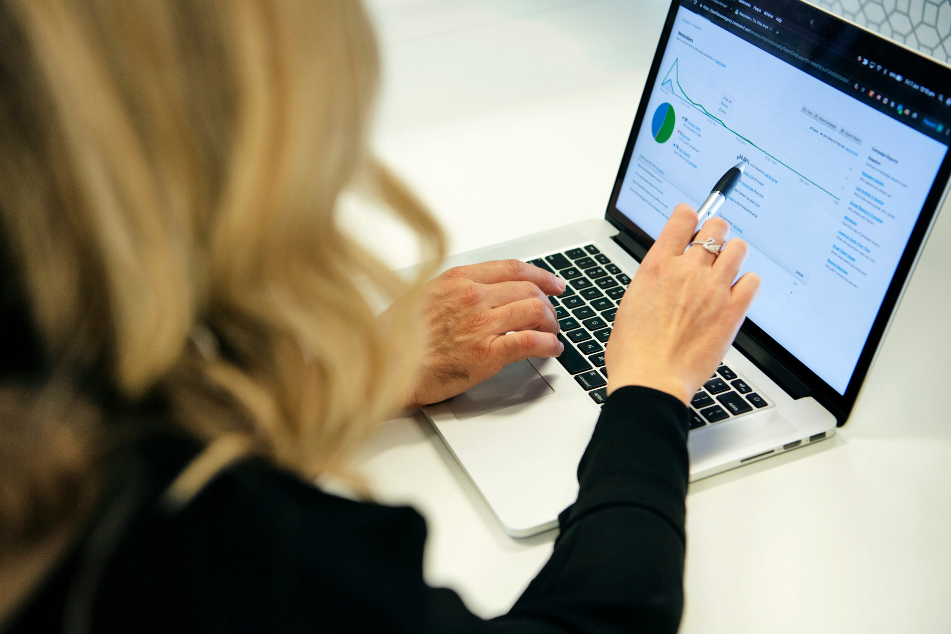 Marketing professional reviewing campaign performance data on a laptop